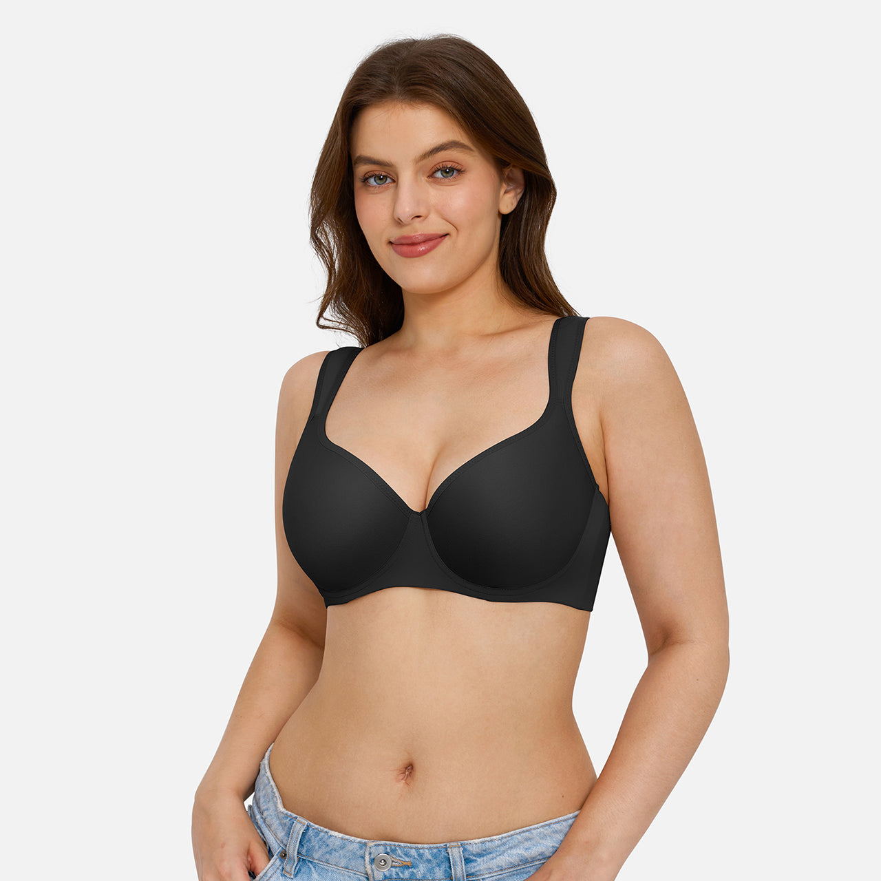 A woman modeling a black wireless bra against a light gray studio background.