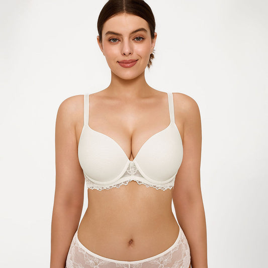 A woman modeling a white underwire bra with delicate lace trim, paired with matching white lace panties, against a solid white studio background.