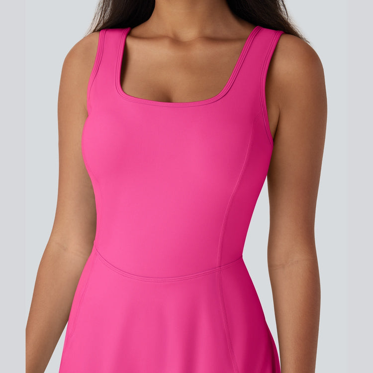 Pink sleeveless dress worn by a person on a light gray background