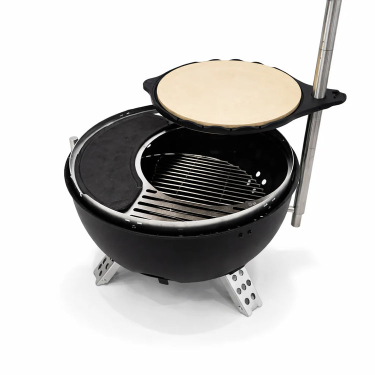 Portable grill with a pizza stone on top, set against a white background