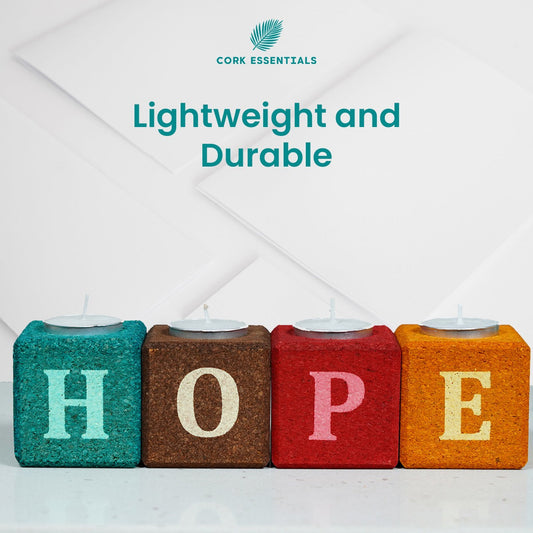 Colorful blocks spelling 'HOPE' with small candles on a white background