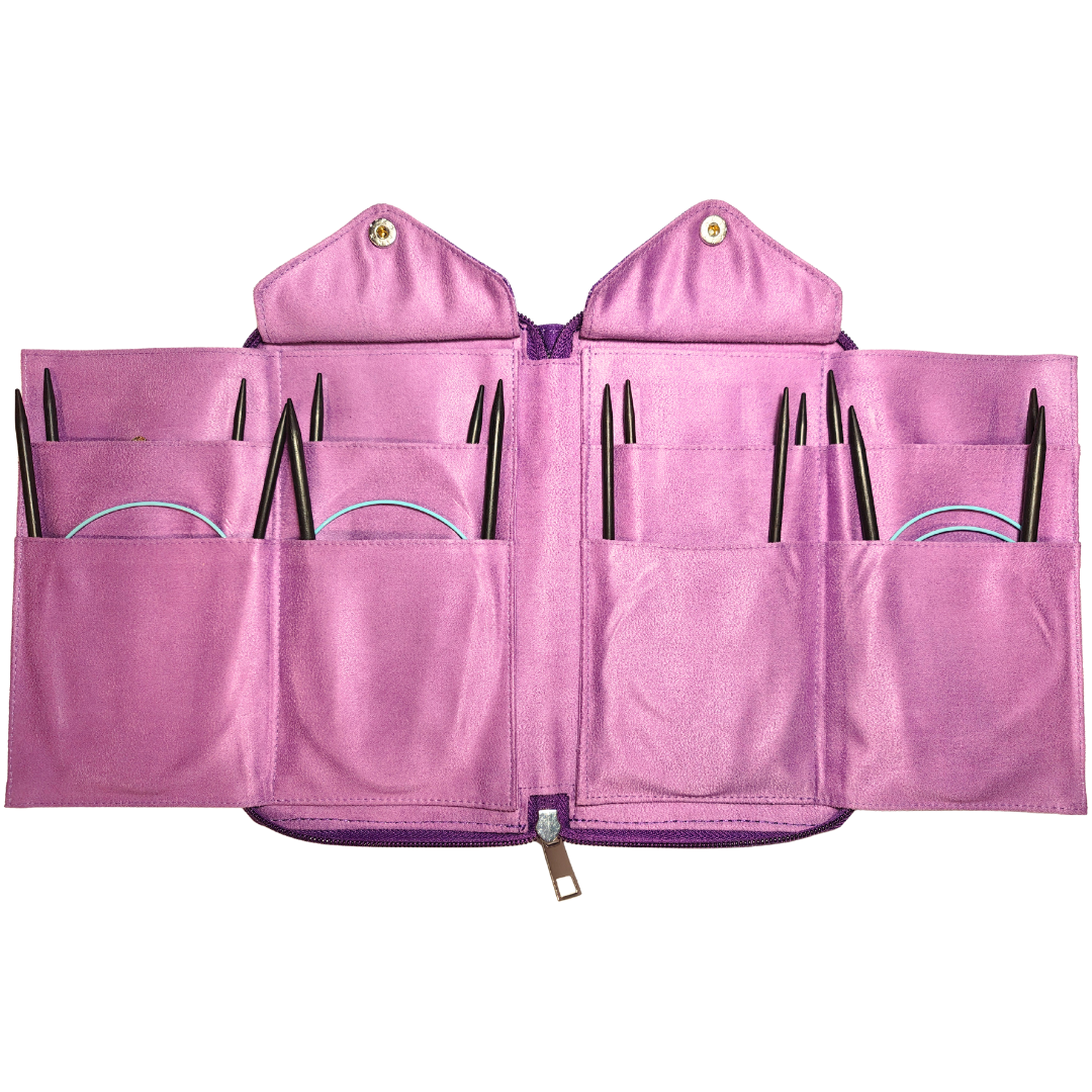 Pink knitting needle case with multiple compartments on a white background