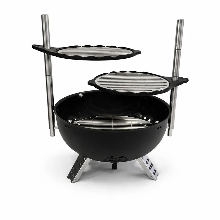 Black portable grill with two additional cooking surfaces on a white background