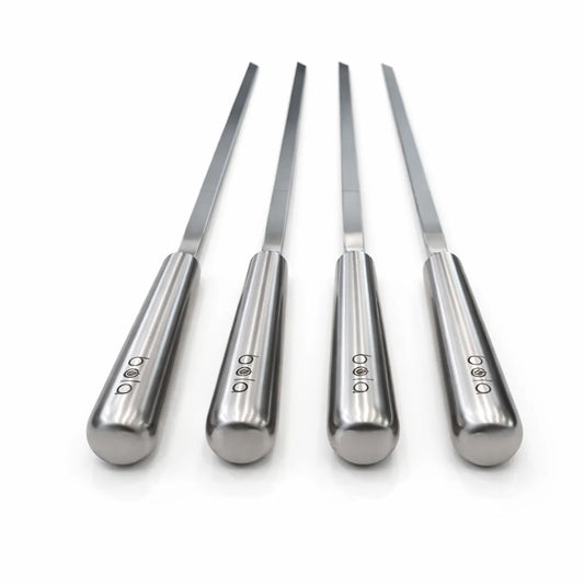 Black portable grill with metal skewers on a white background