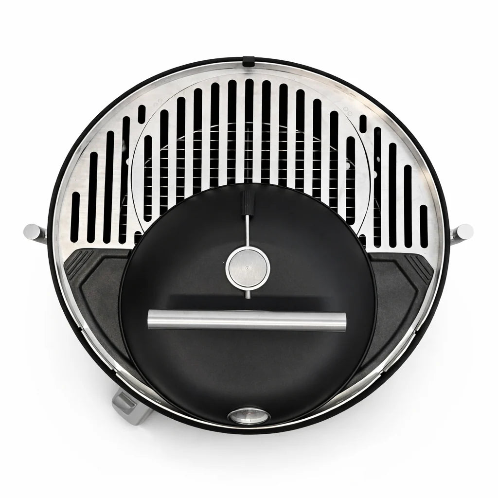 Round grill with black interior and silver exterior on a white background