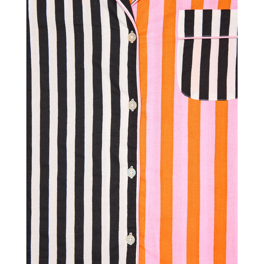 Woman wearing a colorful striped shirt against a white background