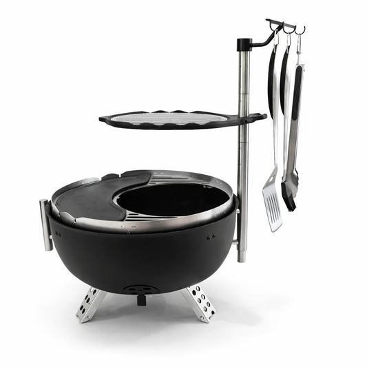 Black portable grill with cooking utensils on a white background