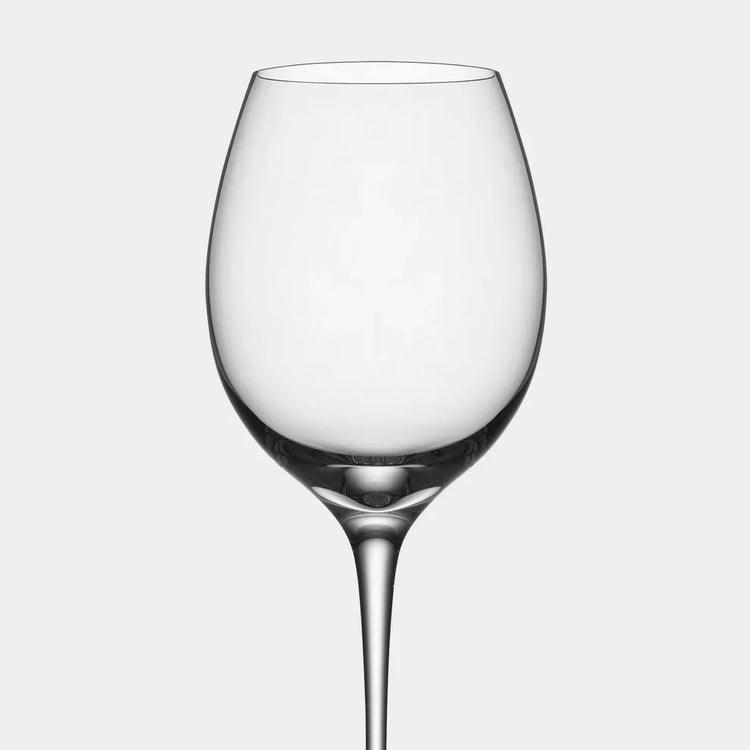 Clear wine glass on a light gray background