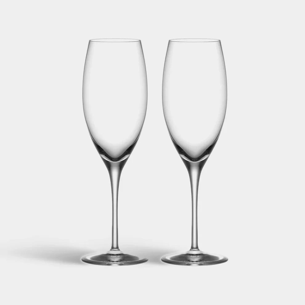 Two clear wine glasses on a light gray background