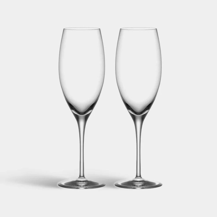 Two clear wine glasses on a light gray background