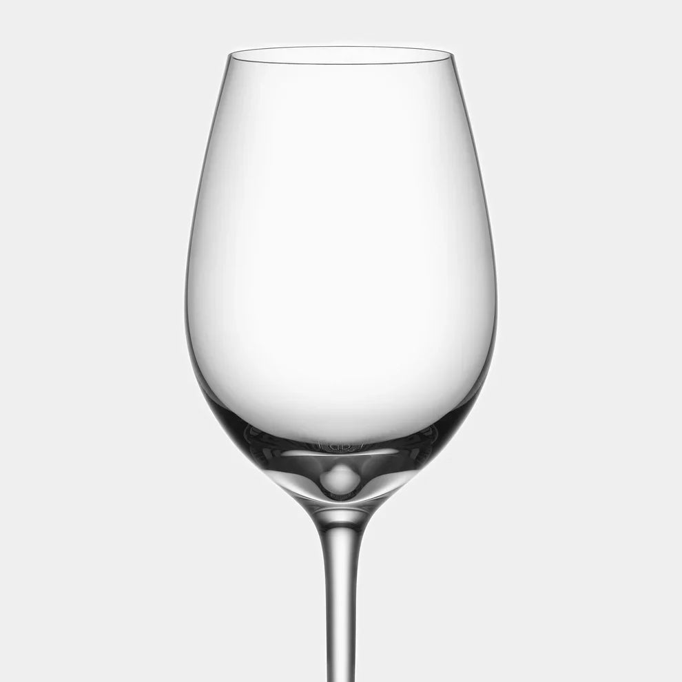 Clear wine glass on a light gray background