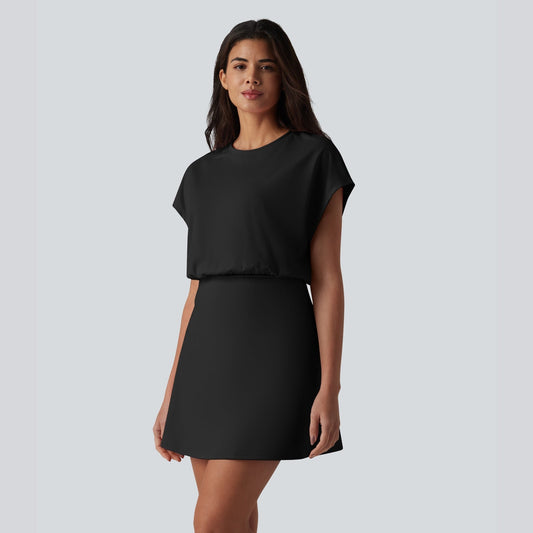 Woman wearing a black dress against a plain background