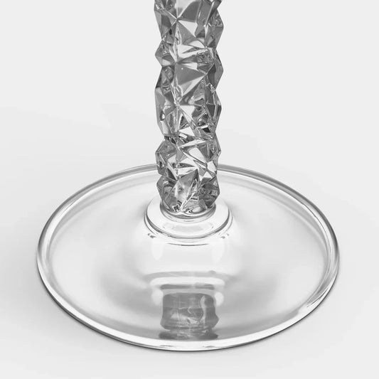 Two clear glass champagne flutes with intricate designs on a white background