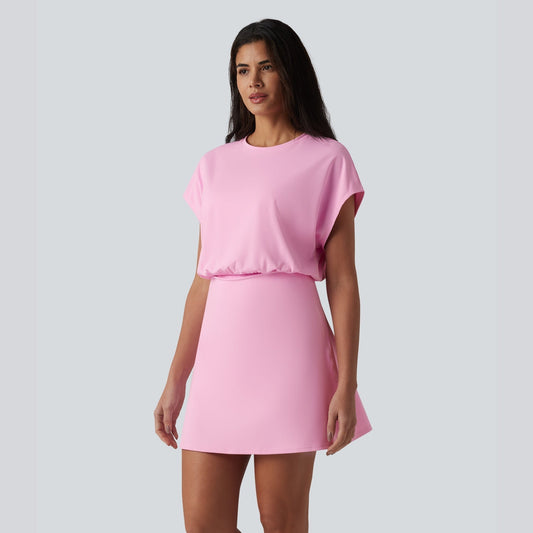 Woman wearing a pink dress against a plain background