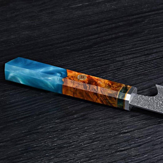 Sakao Damascus kitchen knife with wooden handle and branded packaging on a white background