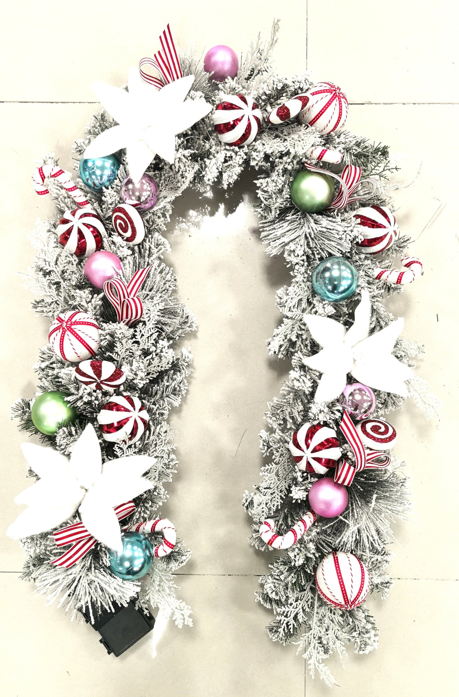 Decorative Christmas garland with colorful ornaments on a white background
