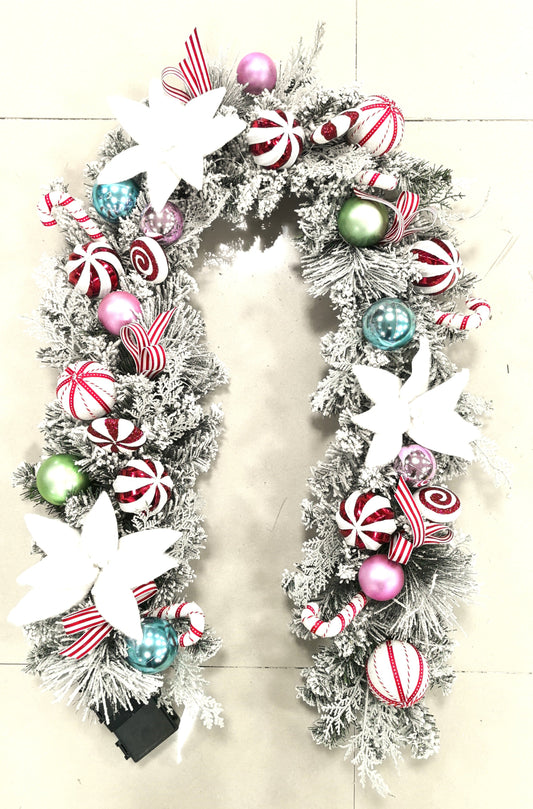 Decorative Christmas garland with colorful ornaments on a white background