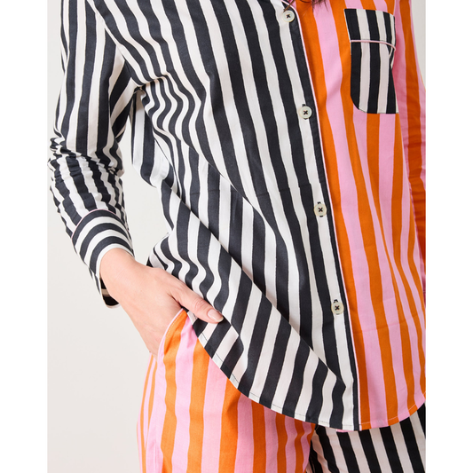 Woman wearing a colorful striped shirt against a white background