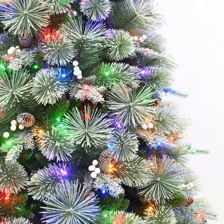 Decorated Christmas tree with colorful lights and pinecones on a white background