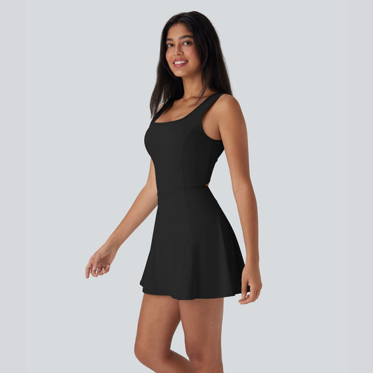 Woman wearing a black dress against a plain background