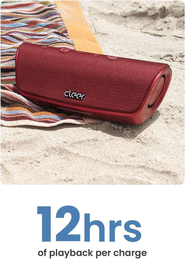 Red portable speaker on a sandy surface with a colorful towel, labeled 'cleer' and showing battery life text.