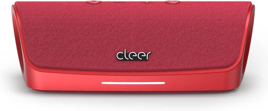Red portable speaker with 'cleer' branding on a concrete surface outdoors.