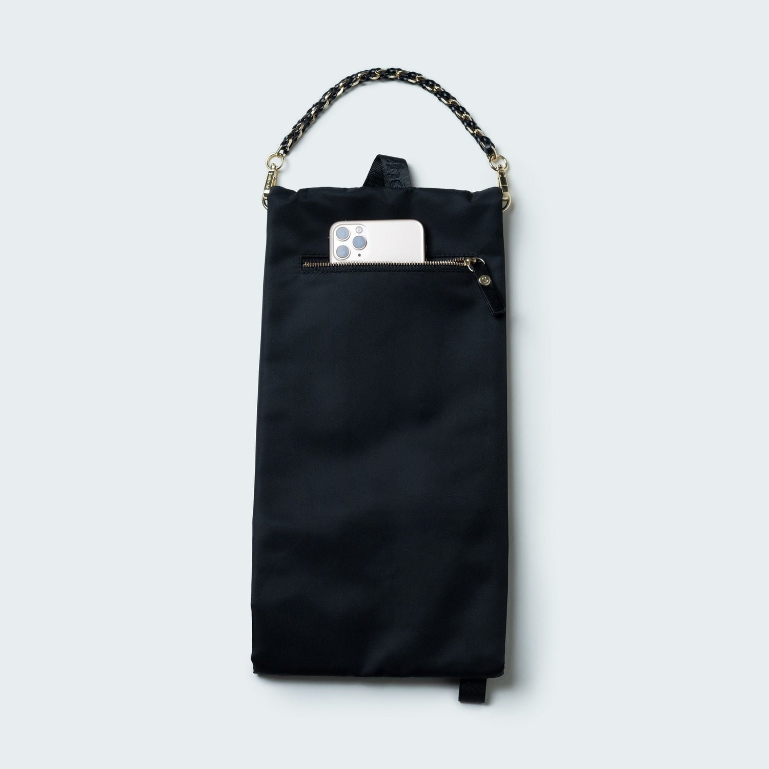 Black handbag with a chain handle on a light gray background