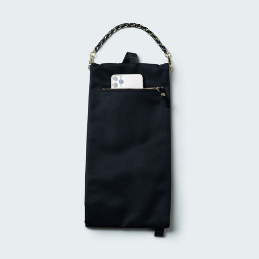 Black handbag with chain detail on a white background