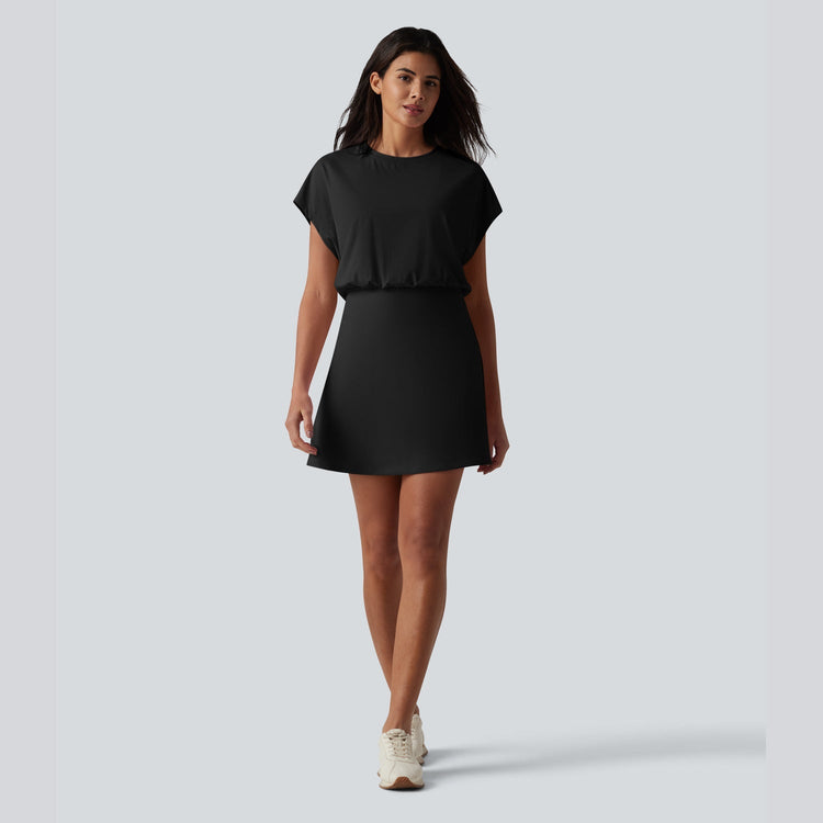 Woman wearing a black dress on a light gray background