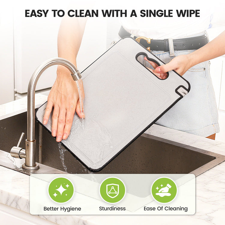 Person washing a cutting board with a cleaning cloth over a sink, emphasizing ease of cleaning.