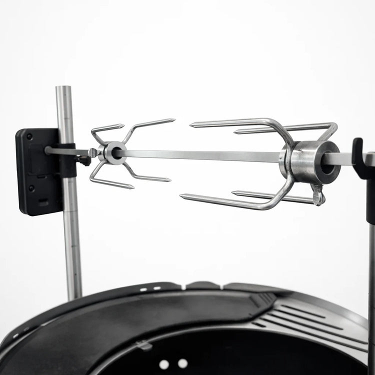 Metal whisk attachment on a stand mixer with a white background