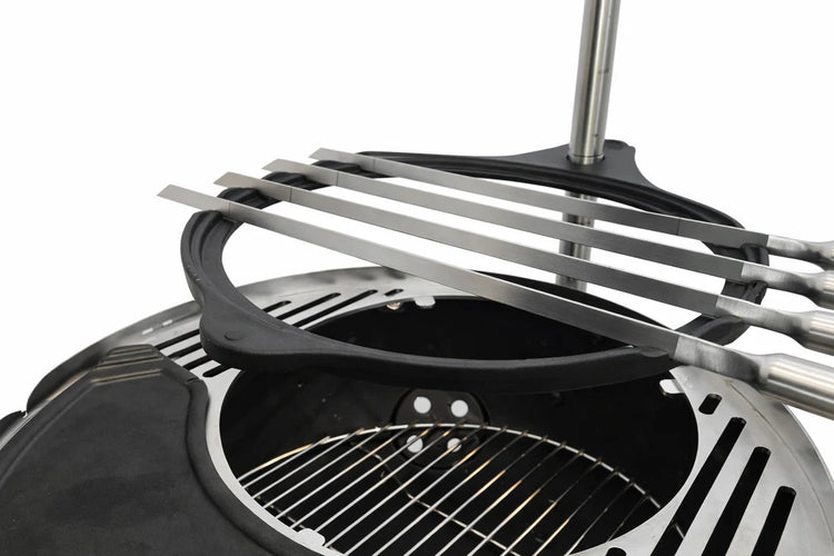 Stainless steel spatula on a grill with a white background
