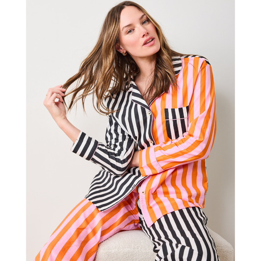 Woman wearing a colorful striped shirt against a white background