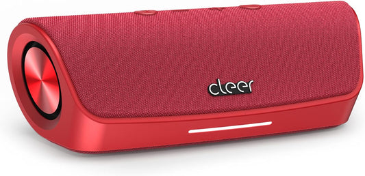 Red portable speaker with 'cleer' branding on a concrete surface outdoors.