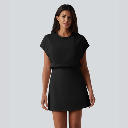 Woman wearing a black dress against a plain background