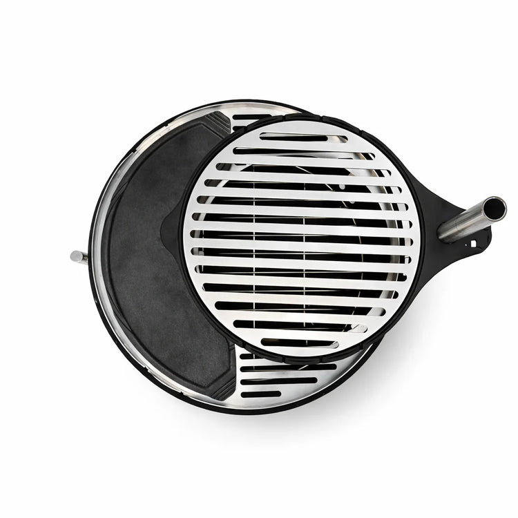 Round metal grill with black interior on a white background