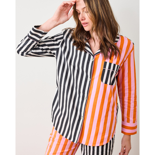 Woman wearing a colorful striped shirt against a white background