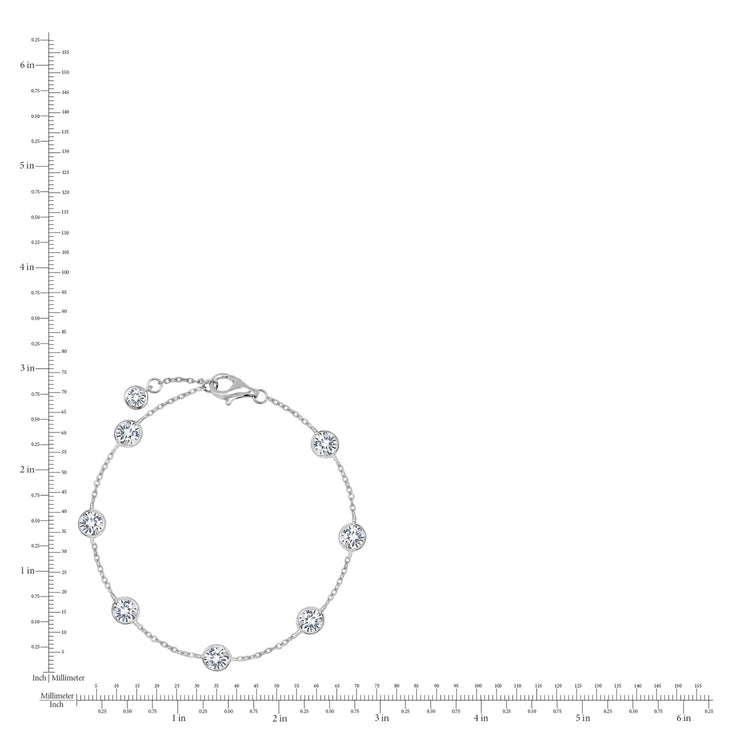 Silver bracelet with floral designs on a white background with a ruler for scale.