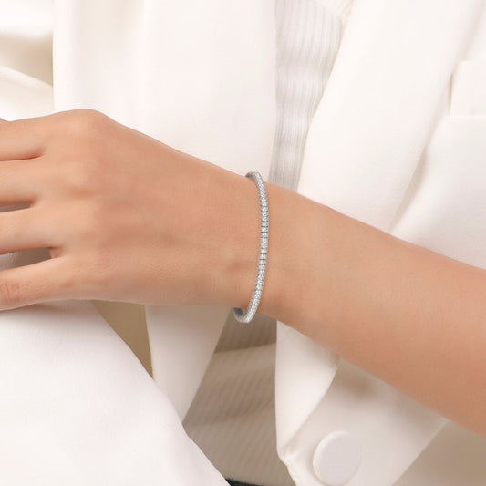 Silver bracelet with clear stones on a white background
