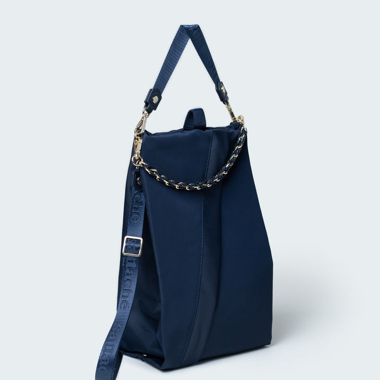 Navy blue handbag with a chain detail on a light gray background