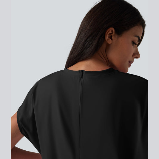Woman wearing a black dress against a plain background