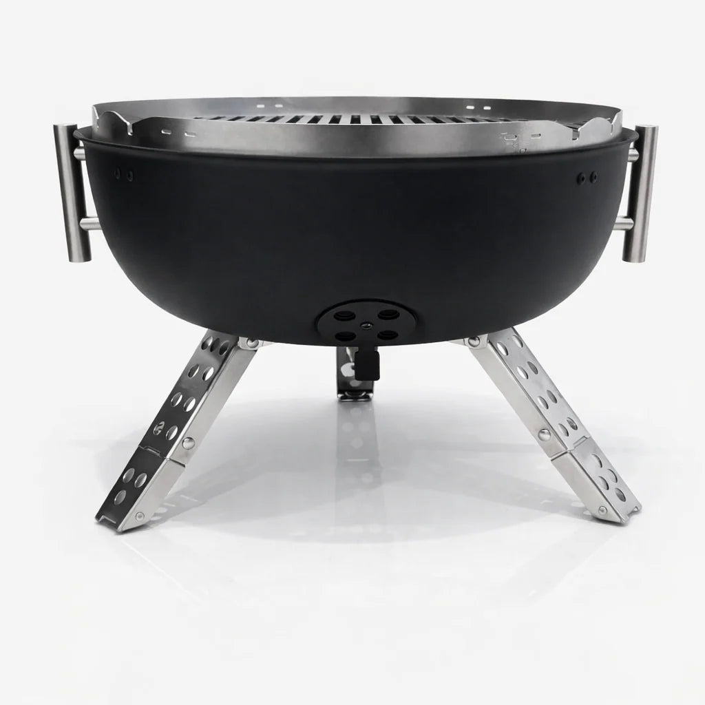 Black portable fire pit with metal legs on a white background