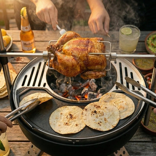 Grill with skewers of meat over an open flame on a wooden deck.