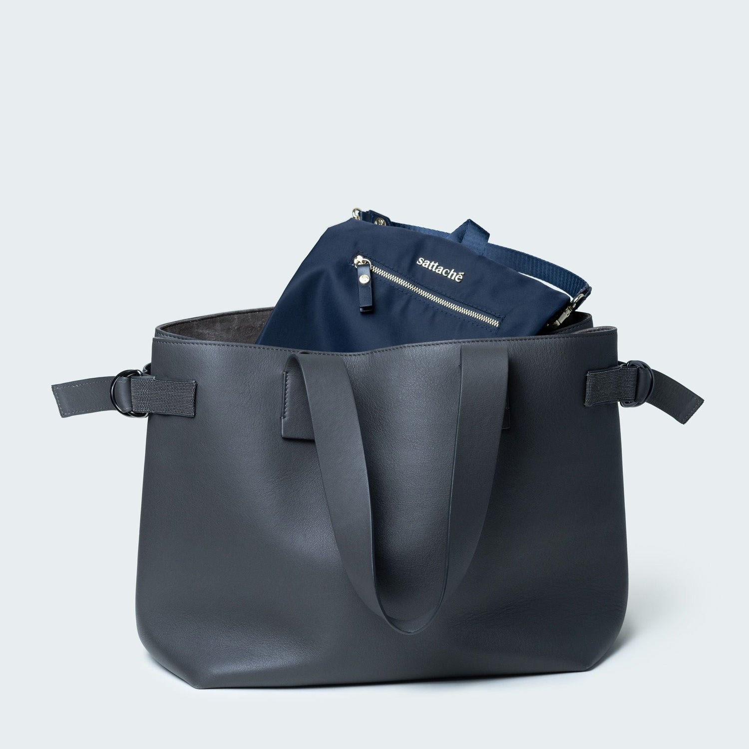 Gray tote bag with a navy pouch inside on a light gray background