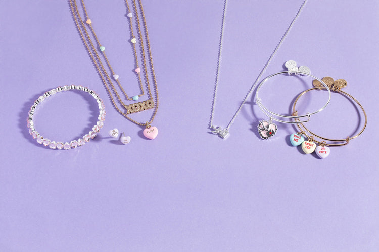 Jewelry set including necklaces and bracelets on a purple background