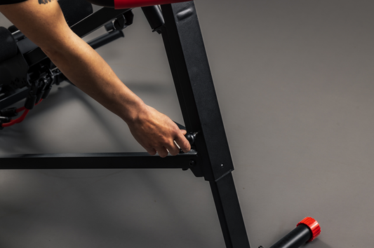 Black and red exercise machine on a gray background