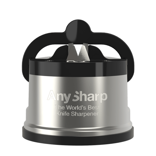 AnySharp Pro Knife Sharpener with a red and black color scheme, attached to a suction cup, being used to sharpen a knife over a kitchen counter.