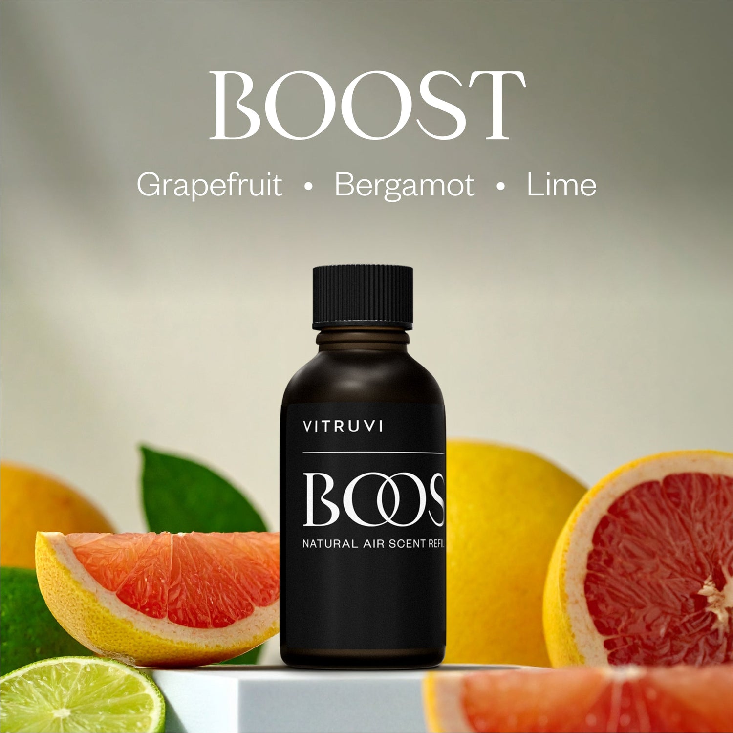 Black bottle labeled 'BOOST' with grapefruit, bergamot, and lime slices on a neutral background