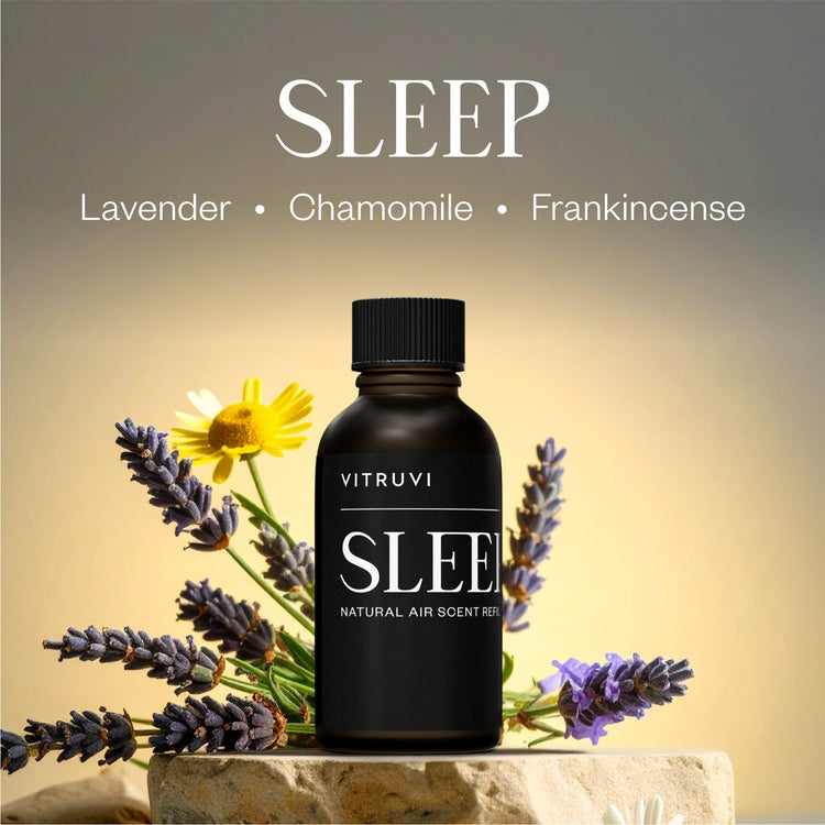 Vitruvi Sleep natural air scent refill bottle with lavender and chamomile flowers on a stone surface.