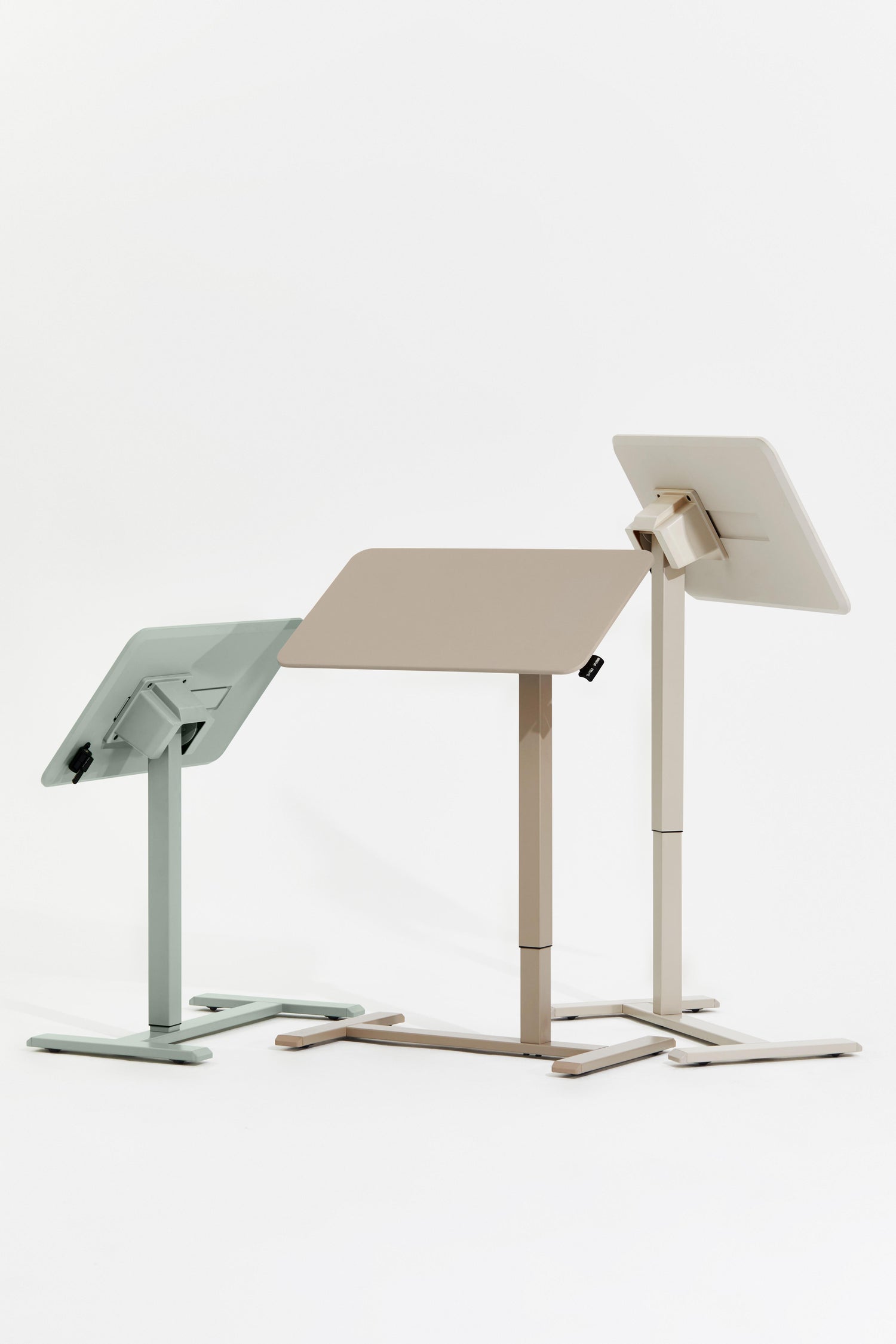 Two adjustable standing desks on a white background